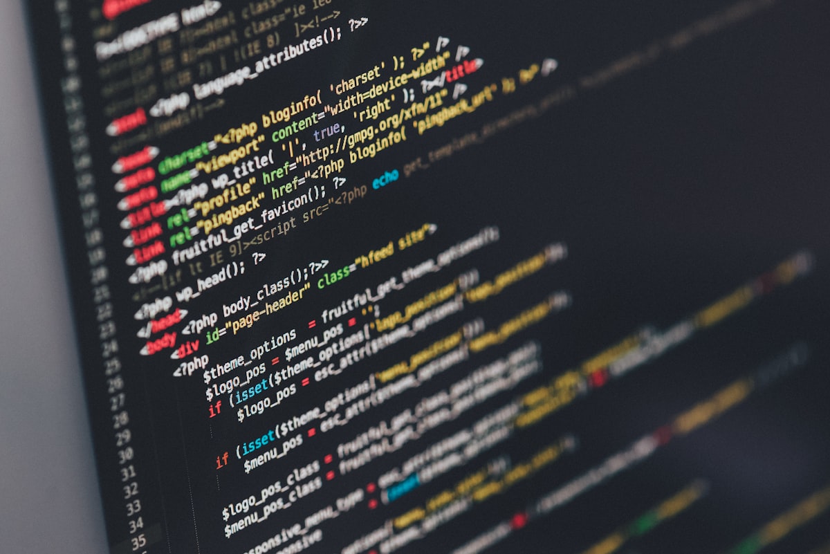 Code on a laptop screen in a dim room